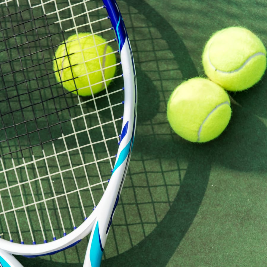 Tennis racket and balls on a court